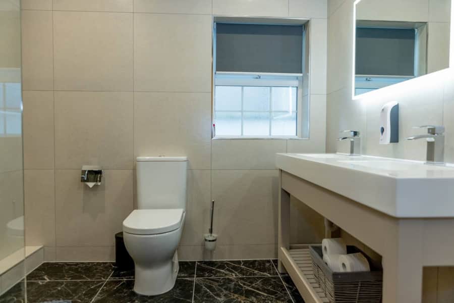 Modern bathroom with walk-in shower in Apartment 1